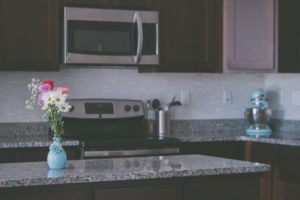 A vase of flowers on a kitchen counter
