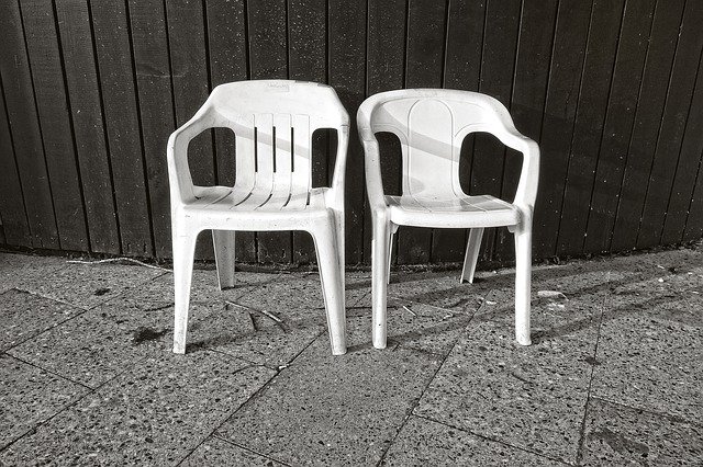 A chair sitting in front of a fence
